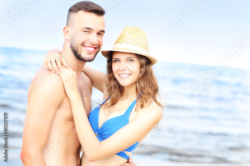 Happy couple posing over the sea