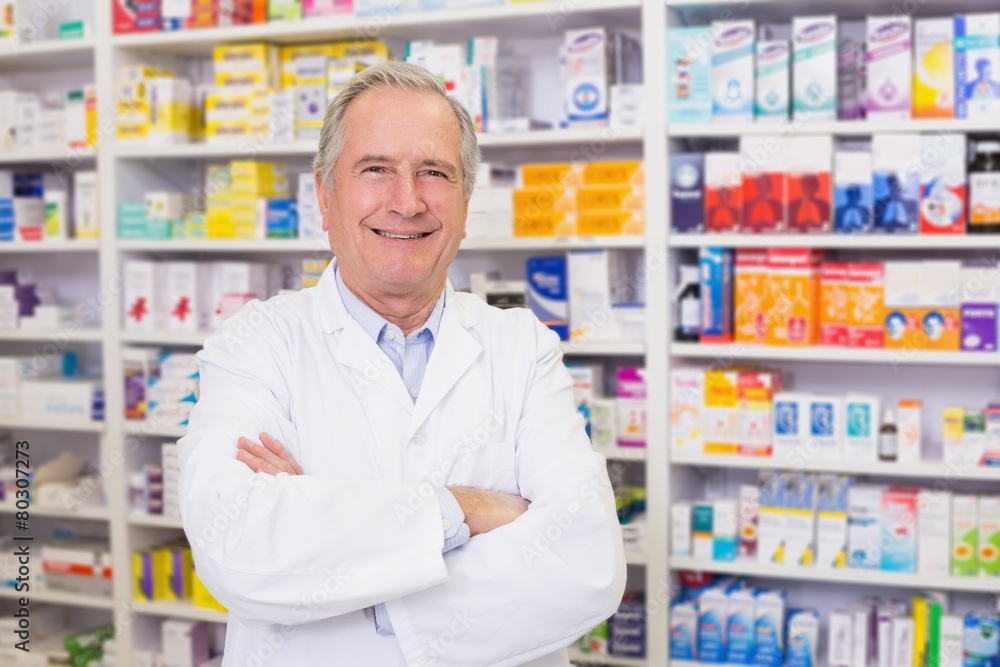 Senior pharmacist smiling at camera