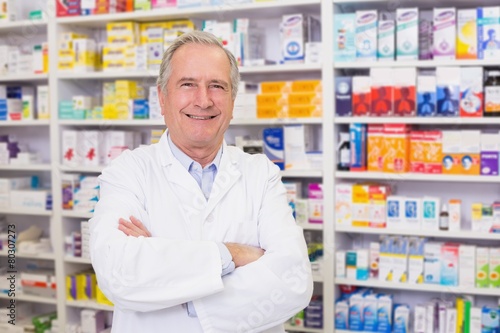 Senior pharmacist smiling at camera