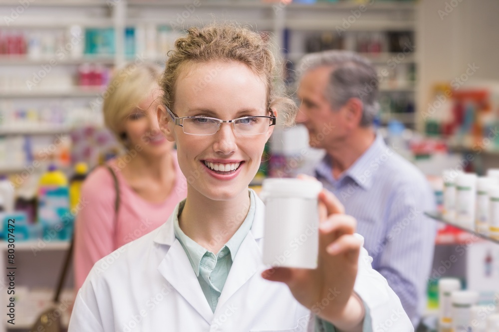 Pharmacist holding medicine jar Pharmacist holding medicine jar