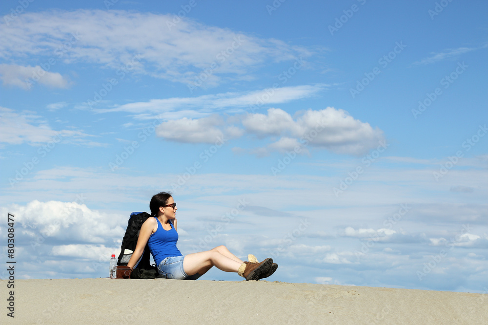 girl hiker is resting in the desert