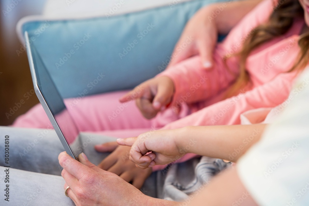 Family on the couch together using tablet pc
