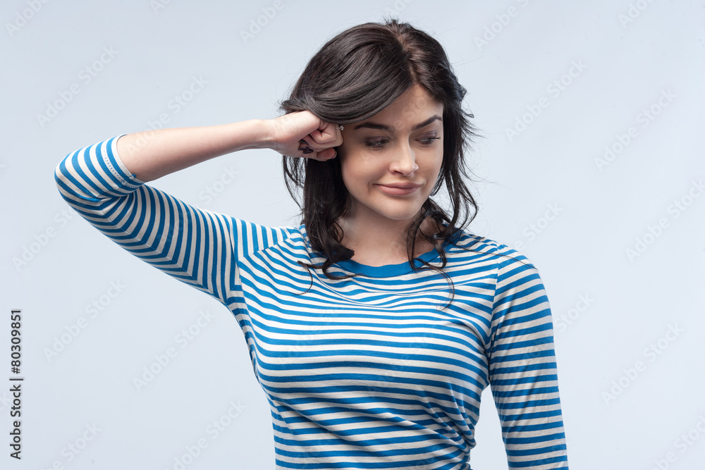 Fototapeta premium Studio portrait of a young woman. Isolated grey background