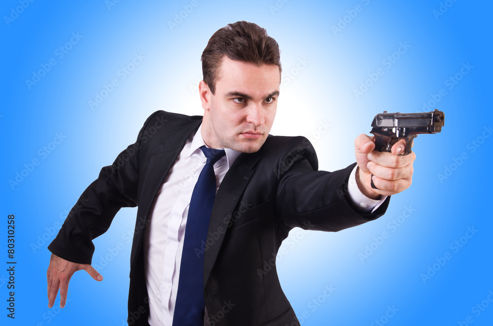 Businessman with gun isolated on white Businessman with gun isolated on white