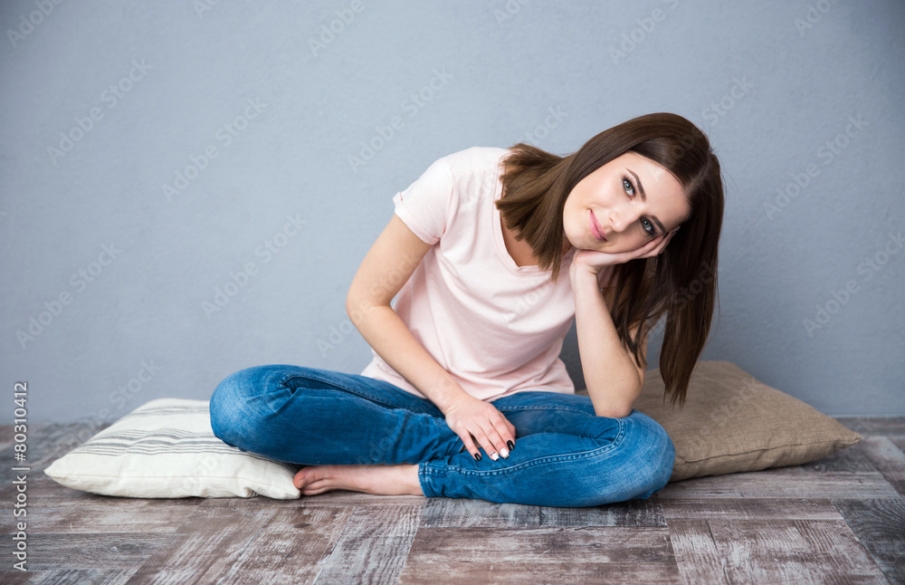 Young cute woman sitting on the floor Young cute woman sitting on the floor