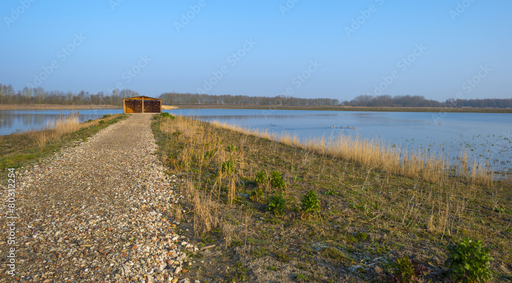 Bird hide on the shore of a lake in winter Bird hide on the shore of a lake in winter