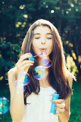 Girl blowing bubbles outdoors