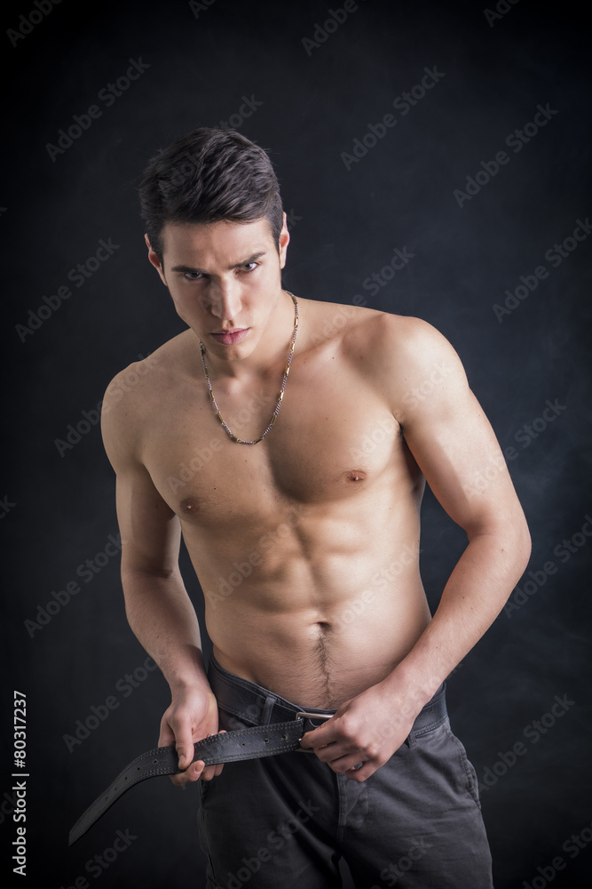Handsome, fit shirtless young man wearing only pants Handsome, fit shirtless young man wearing only pants