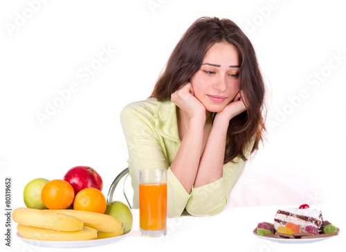 girl chooses between fruit and sweets