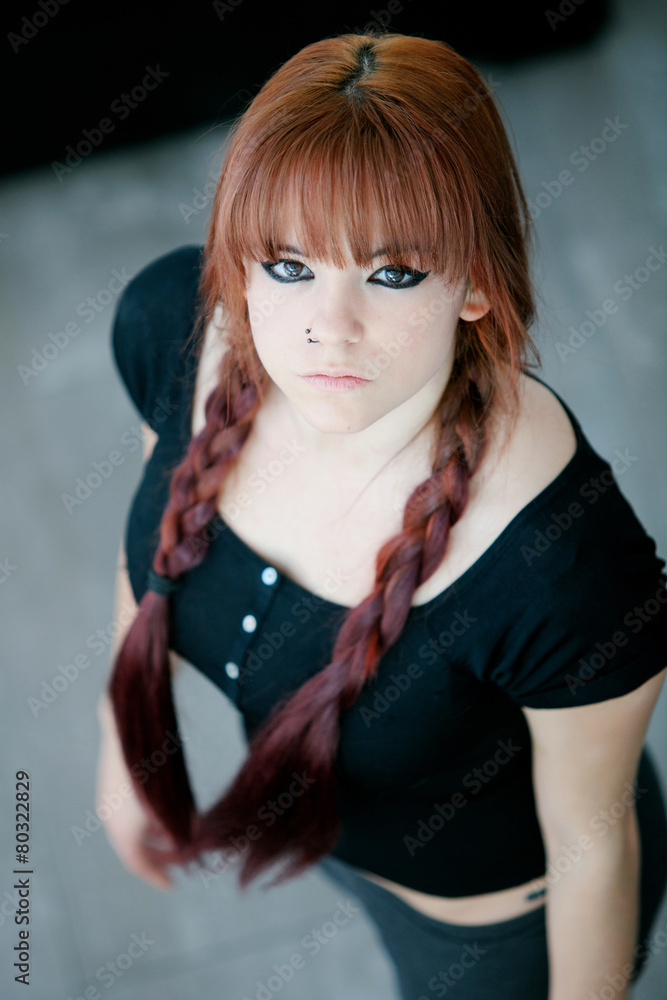 Naklejka premium Rebellious teenager girl with red hair
