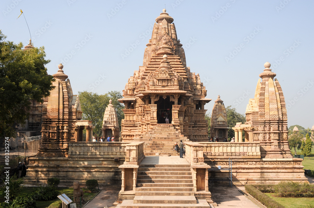 People climb to the hindu temple of Khaiuraho on India