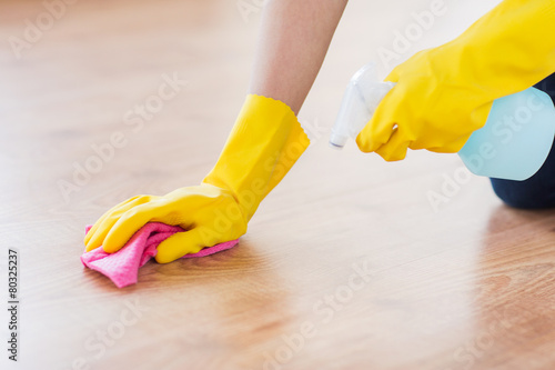 close up of woman with rag cleaning floor at home