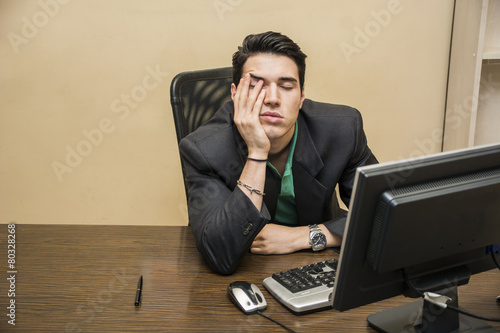 Foto Tired bored young businessman