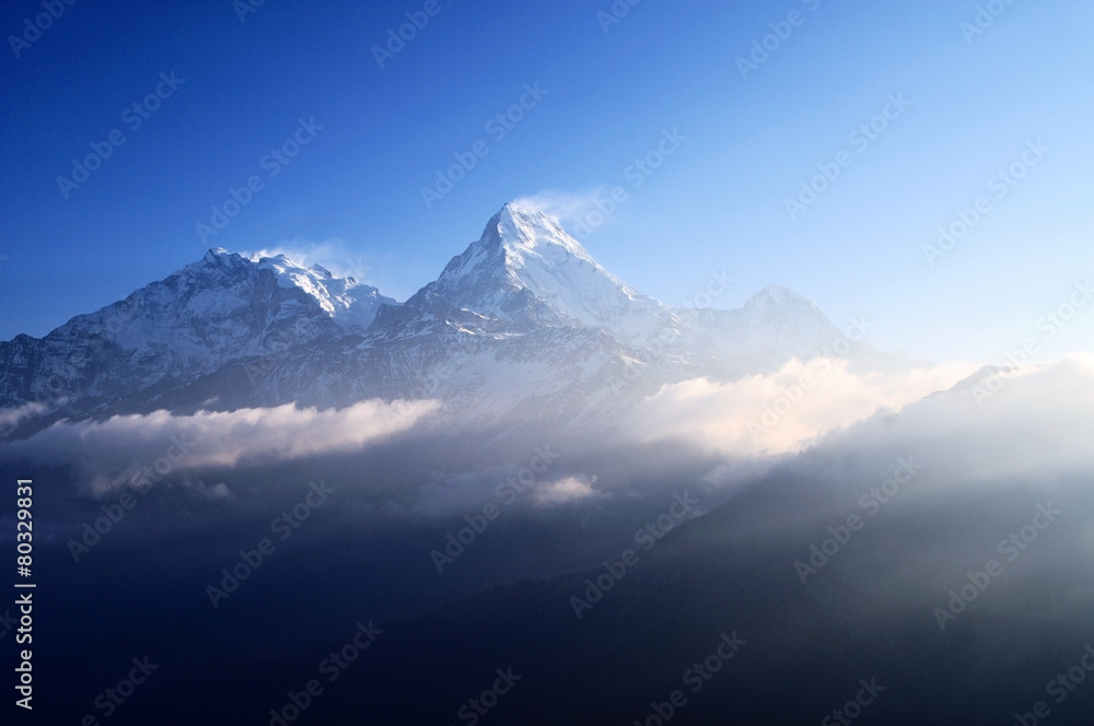 Dramatic sun light over snow capped Annapurna mountain