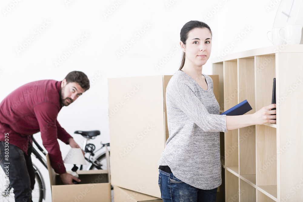 beautiful young couple unpacking at new home beautiful young couple unpacking at new home