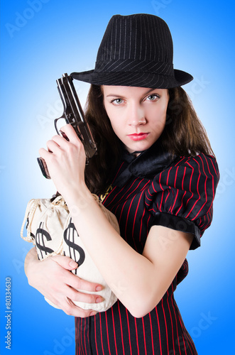 Woman gangster with handgun on white © Elnur