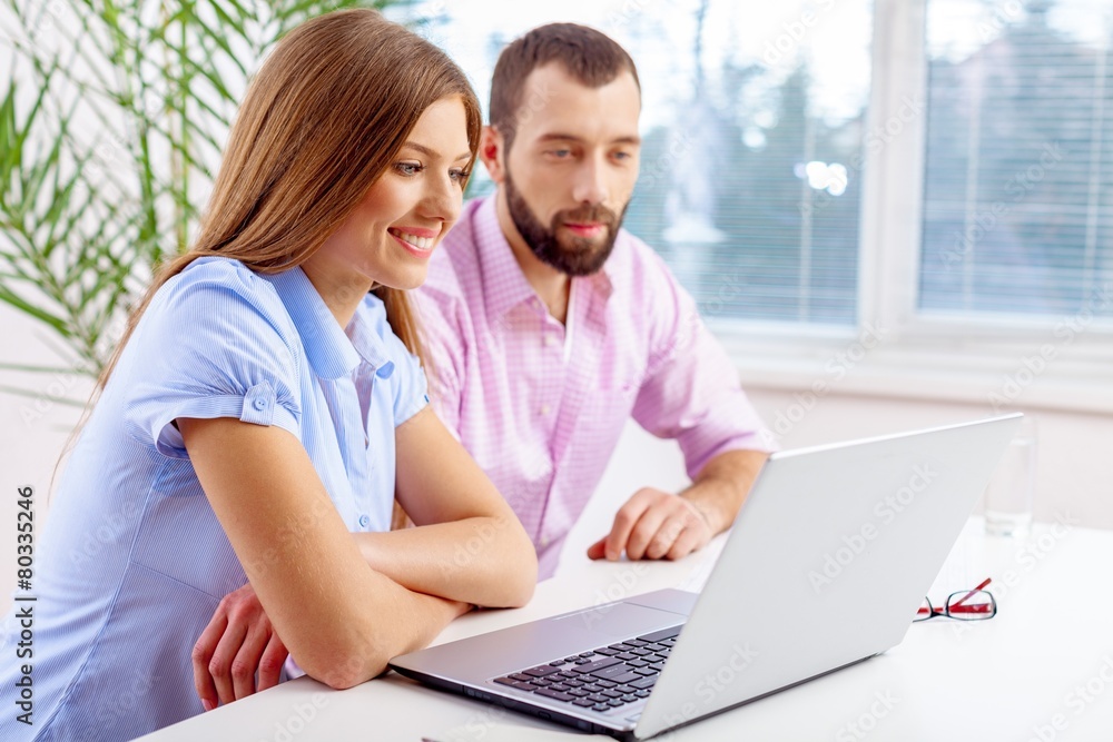 Laptop. Business team consisting of a young man and woman Laptop. Business team consisting of a young man and woman