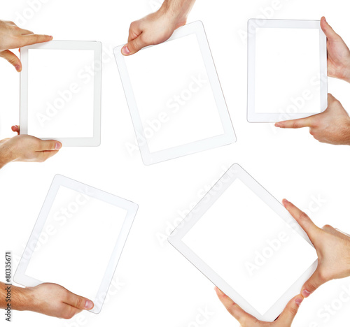 Hands holding tablets isolated on white
