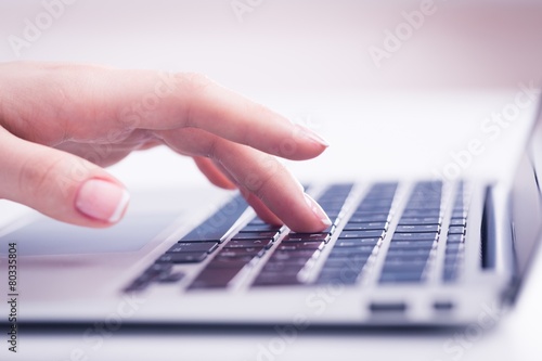 Information. Woman's hand typing on computer keyboard