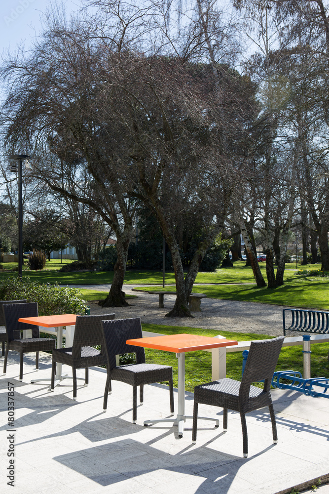 View of a coffee terrace in the garden with tables and chairs