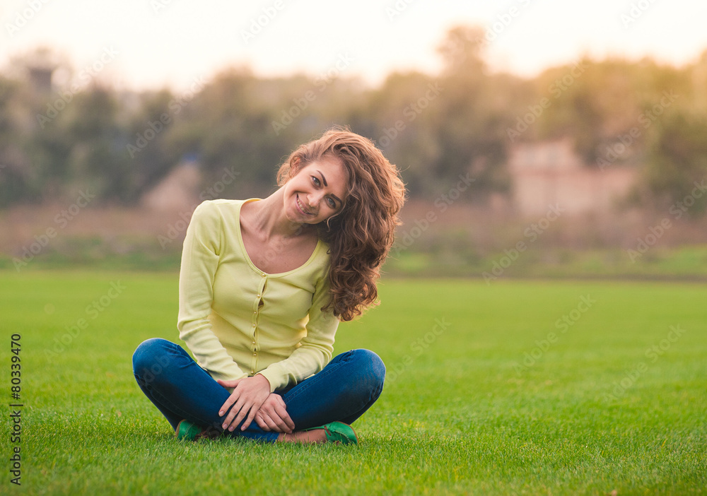 Fototapeta premium Beautiful girl smiling happy looking at camera in lotus pose