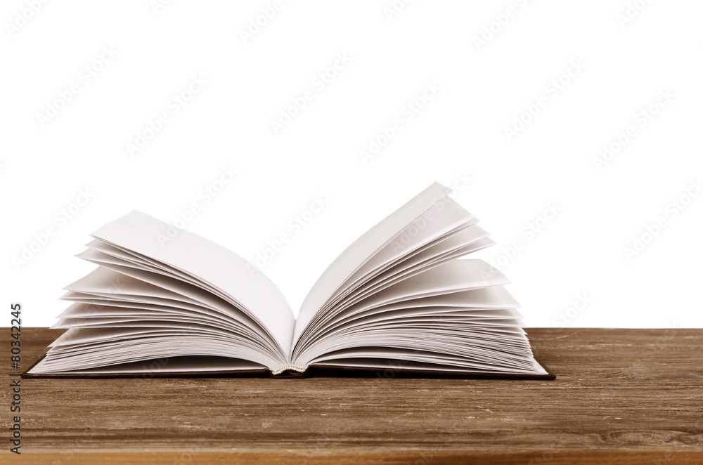 Abstract. Open book on table in front of spring background Abstract. Open book on table in front of spring background