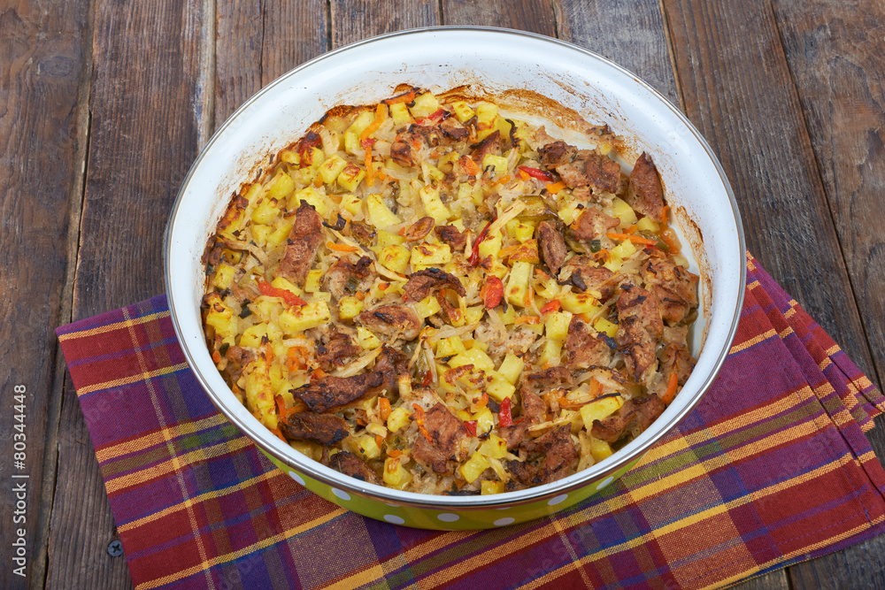 Meat with vegetables, stew on a wooden table Meat with vegetables, stew on a wooden table