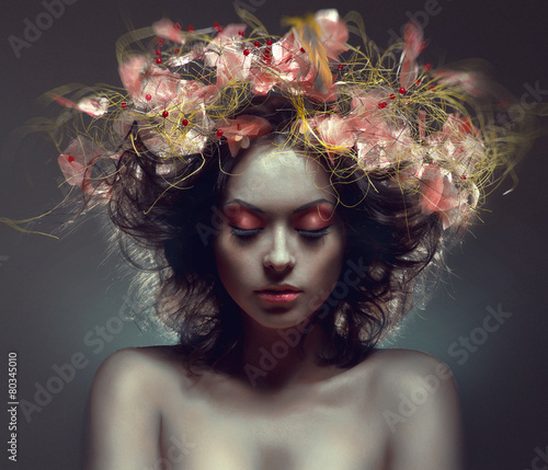 Creative beauty portrait with pink wraith in hair