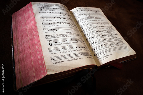 Vintage psalm book with chorus singing notes