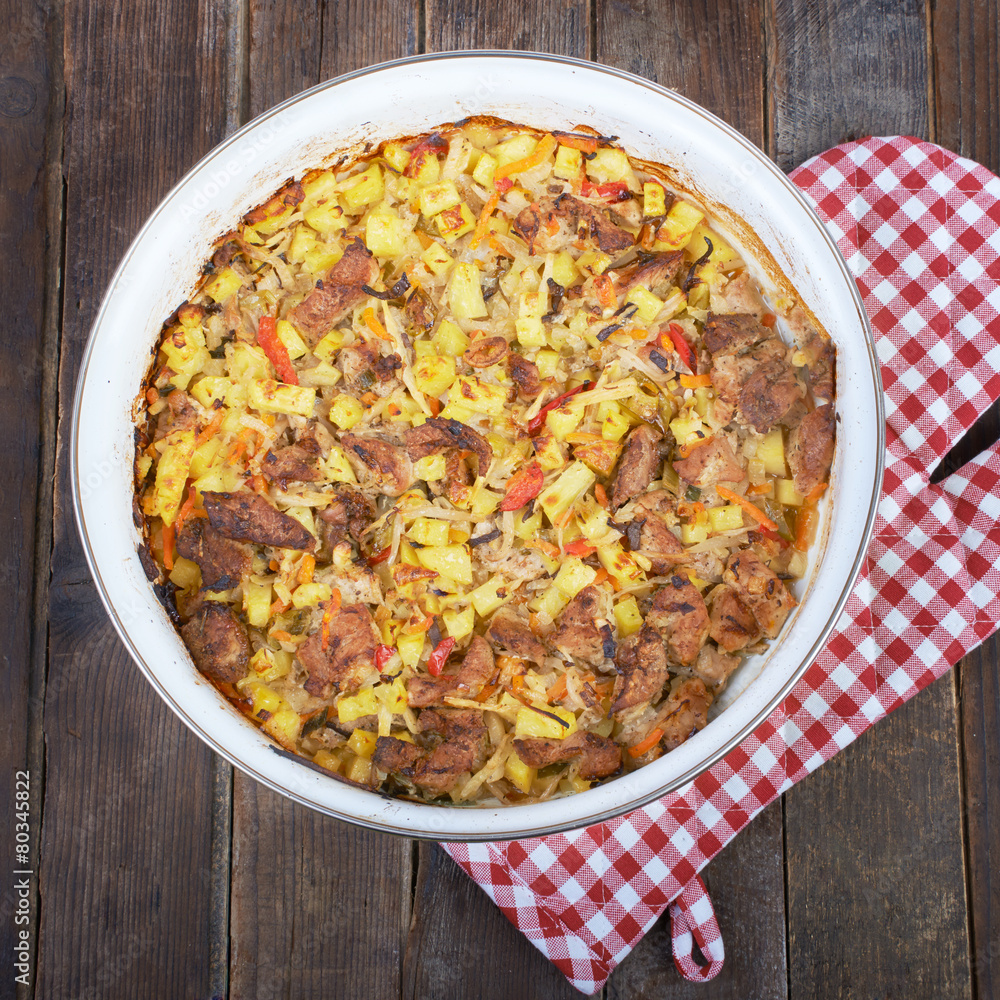 Meat with vegetables, stew on a wooden table