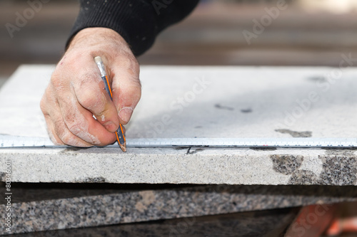 Workers are working, cutting marble cutter