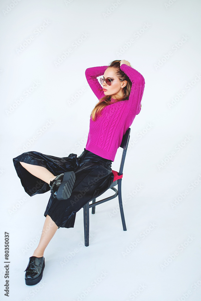 Fototapeta premium Trendy woman model with chair in pink on isolated background