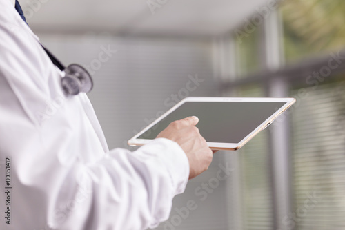 Close-up of a doctor working with a digital tablet