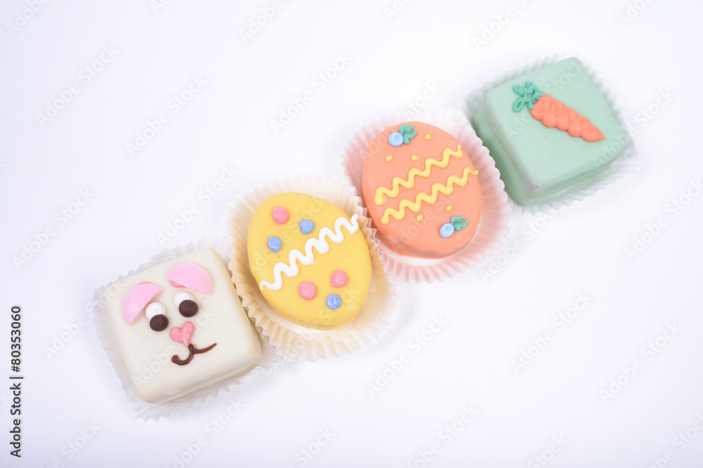 Four small bright Easter cakes in a form of bunny and eggs
