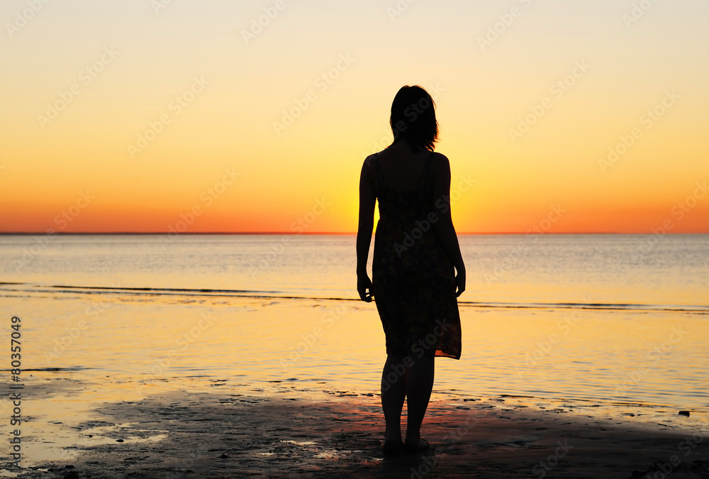 Woman as silhouette by the sea