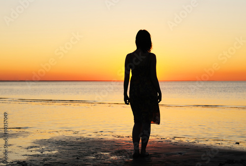 Woman as silhouette by the sea