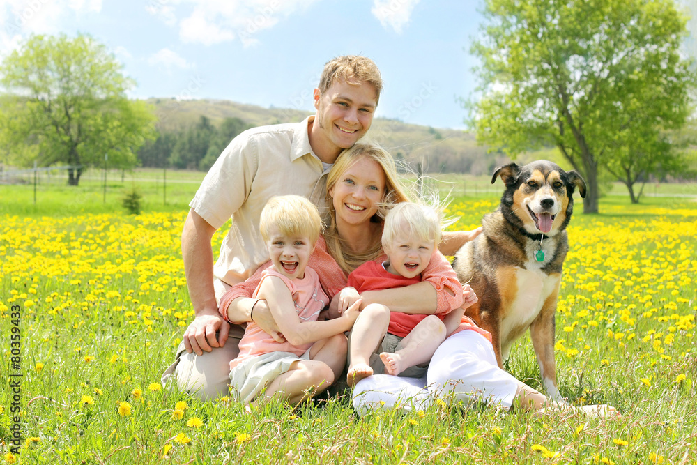 Portrait of Happy Family and Dog in Flower Meadow Portrait of Happy Family and Dog in Flower Meadow
