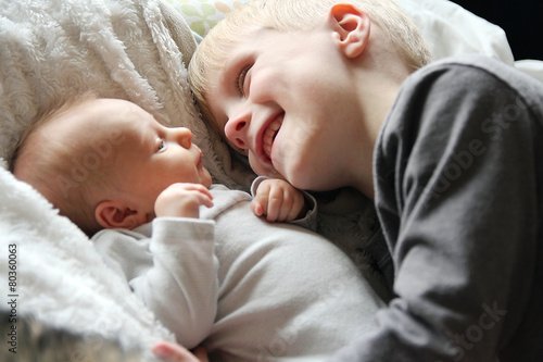 фотографія Big Brother Looking at Newborn Baby with Love