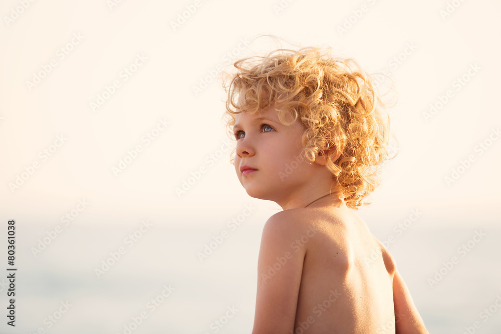 Adorable happy little girl on beach vacation, close up portrait Adorable happy little girl on beach vacation, close up portrait