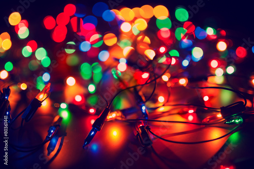 Christmas lights on dark background. Decorative garland. Tinted