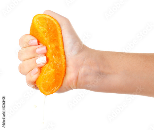 Fotografia Female hand squeezing orange isolated on white