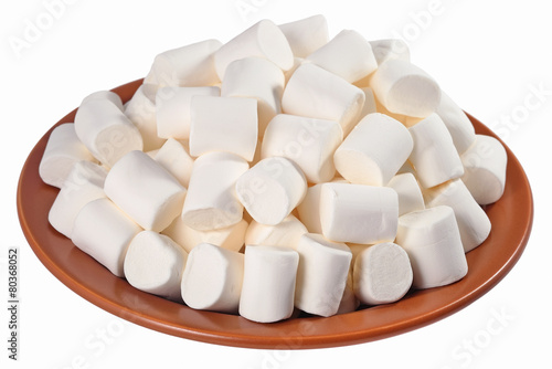 White marshmallow on a ceramic plate on a white