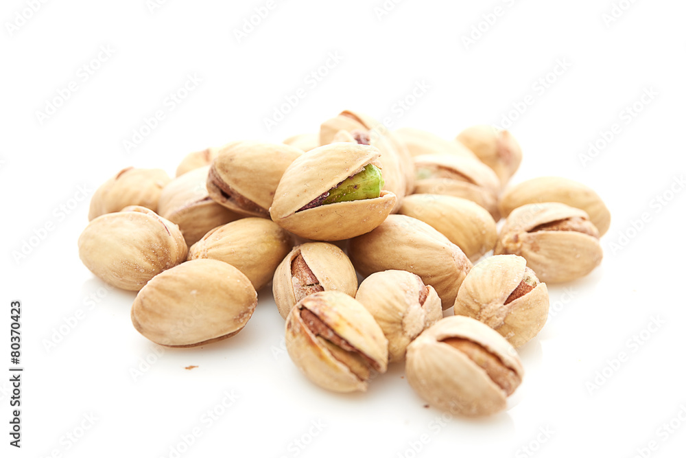 Heap of pistachios nuts isolated on the white Heap of pistachios nuts isolated on the white