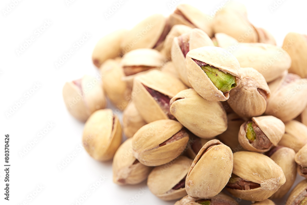 Heap of pistachios nuts isolated on the white Heap of pistachios nuts isolated on the white