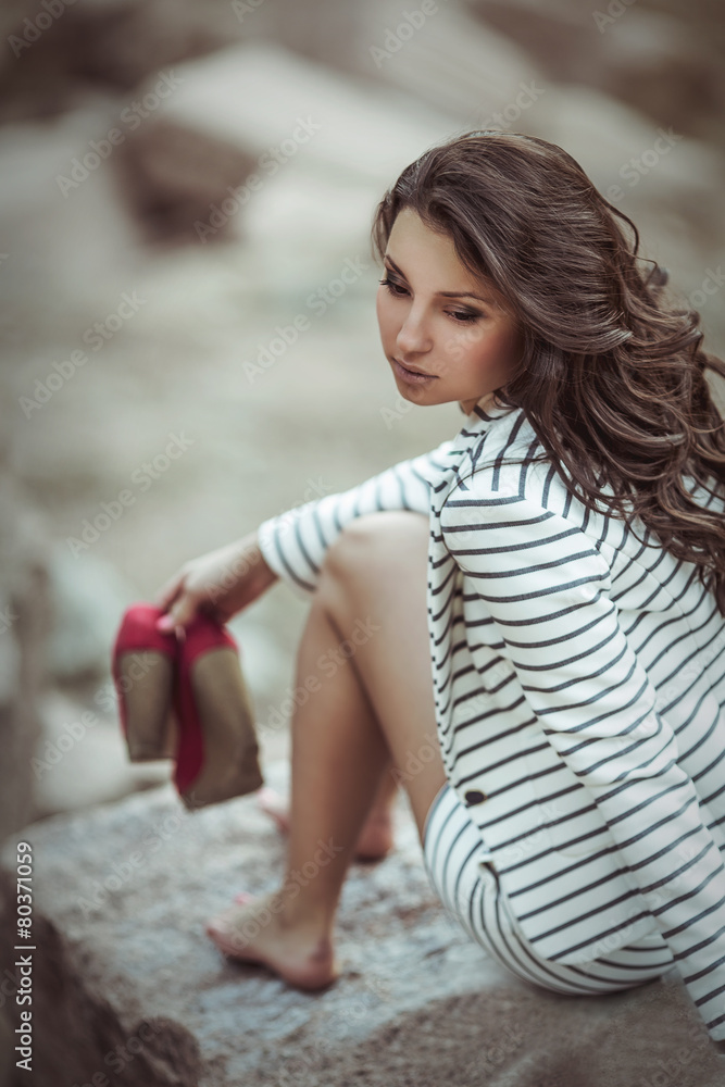 girl sitting on a rock girl sitting on a rock