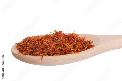 saffron in a wooden spoon,  isolated on a white background