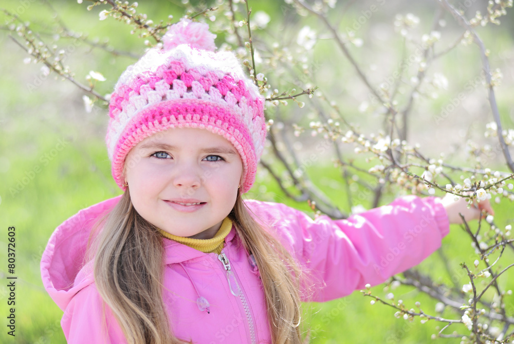 beautiful little girl near a flowering tree beautiful little girl near a flowering tree