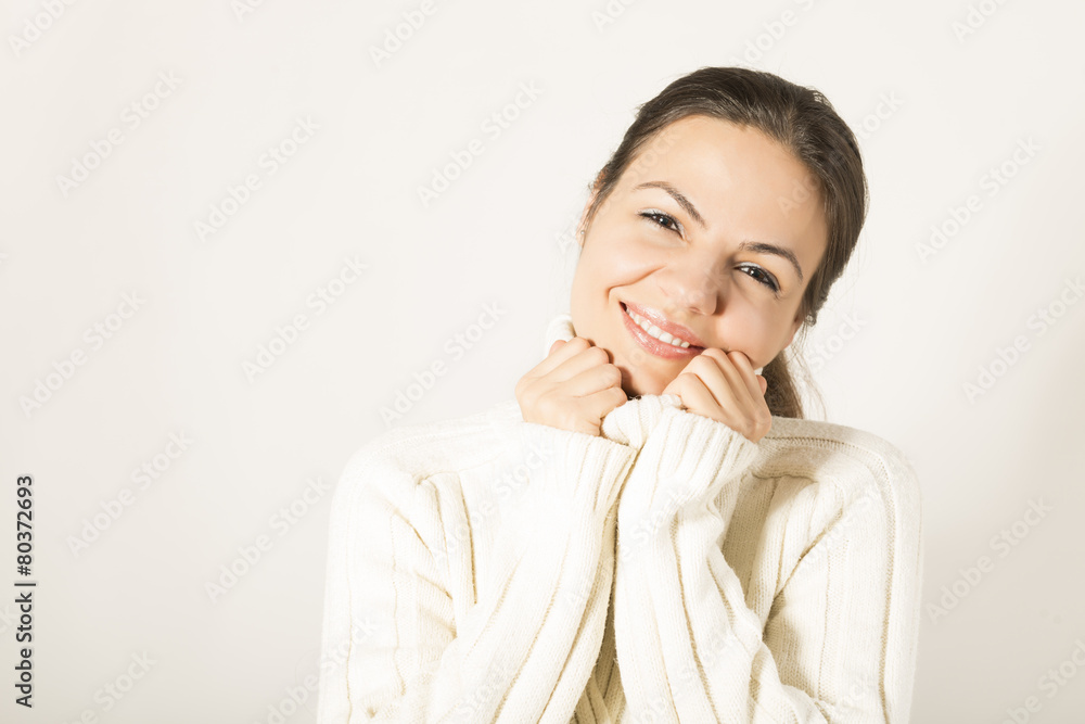 Beautiful woman in warm clothing on white background smiling Beautiful woman in warm clothing on white background smiling