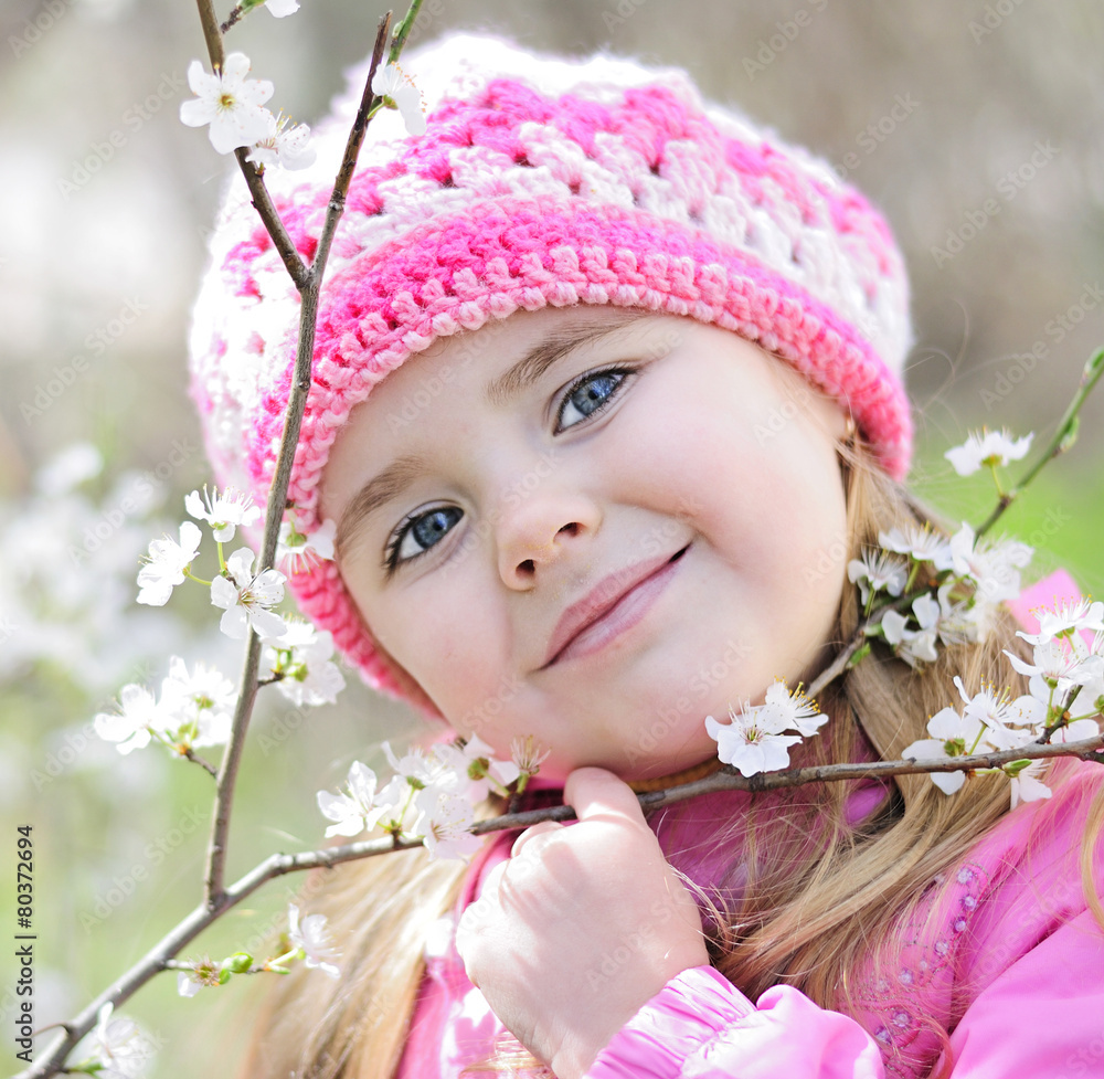 beautiful little girl near a flowering tree beautiful little girl near a flowering tree