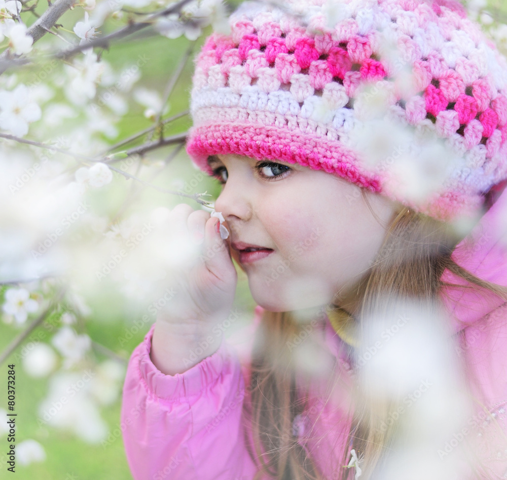 beautiful little girl near a flowering tree beautiful little girl near a flowering tree